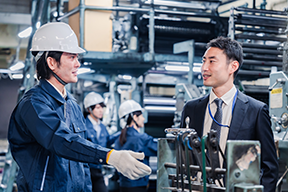 Two men talking in a manufacturing warehouse