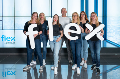 Flex employees in Hungary hold individual letters that make up the flex logo